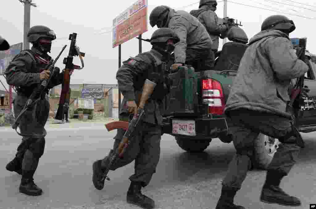 Afghan police arrive at the site of a suicide car bomb attack on the Jalalabad-Kabul road in Kabul, Afghanistan, Dec. 27, 2013. 