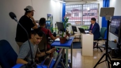 FILE - Nicaraguan journalist Hector Rosales, right, does a virtual interview from a studio-apartment used by Nicaraguan journalists in exile who report on their home country from San Jose, Costa Rica, Aug. 29, 2022. 