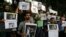 Indian journalists hold placards protesting against the attack on journalists and the arrest of Shahidul Alam, a renowned photographer and Bangladeshi activist as they gather outside Press Club in Kolkata, India, Wednesday, Aug. 8, 2018.