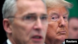 U.S. President Donald Trump reacts next to NATO Secretary General Jens Stoltenberg as they attend a working lunch during the NATO leaders summit in Watford, Britain, December 4, 2019. 