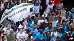 Demonstrators walk through the streets of Nairobi, Oct. 3, 2015, participating in a Global March to support wildlife Elephants and Rhinos.