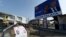 Panneau d'affichage de campagne du président sortant Patrice Talon et de sa vice-présidente Mariam Talata, face à l'affiche de campagne de l'opposition Corentin Kohoue et de la vice-candidate Irene Agossa, à Cotonou le 7 avril 2021.