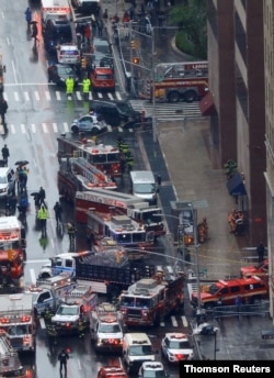 Emergency vehicles are seen outside 787 7th Avenue in midtown Manhattan where a helicopter crashed in New York, June 10, 2019.