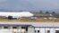 Officials inspect a Saudi Air Boeing 747 cargo aircraft after it overran the runway crashing into a tanker truck at the Nnamdi Azikiwe International Airport in Abuja, Dec. 5, 2013.