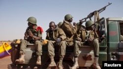 Malian soldiers heading to Gao in a pickup truck arrive in the recently liberated town of Douentza, January 30, 2013. French troops took control on Wednesday of the airport of Mali's northeast town of Kidal, the last urban stronghold held by Islamist rebe