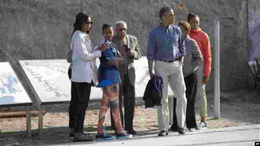 Ahmed Kathrada, a former prisoner with Nelson Mandela, guides Barack Obama through Robben Island prison, South Africa