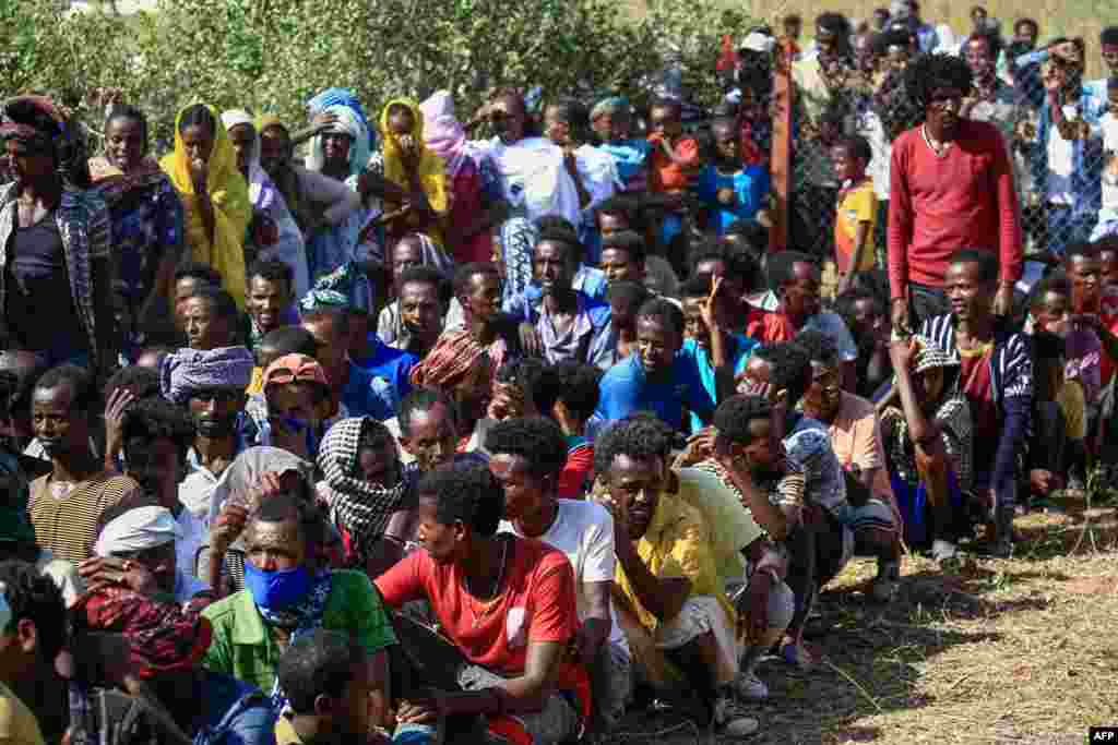 Ethiopian refugees who fled fighting in the Tigray region gather at the Village 8 border reception center in Sudan's eastern Gedaref state, Nov. 20, 2020.