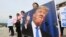 Protesters with a portrait of U.S. President Donald Trump stage a rally against the United States' policies near the U.S. embassy in Seoul, South Korea, May 25, 2018. 