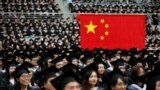 FILE - Students attend a graduation ceremony at Fudan University in Shanghai, June 23, 2017.