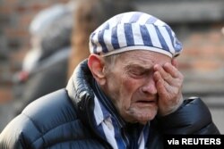 A survivor reacts at the former Nazi German concentration and extermination camp Auschwitz as he attends a wreath-laying ceremony, marking the 75th anniversary of the liberation of the camp, in Oswiecim, Poland, Jan. 27, 2020.