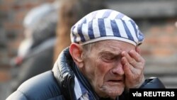 A survivor reacts at the former Nazi German concentration and extermination camp Auschwitz as he attends a wreath-laying ceremony, marking the 75th anniversary of the liberation of the camp, in Oswiecim, Poland, Jan. 27, 2020.