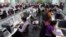 Workers are seen at their workstations on the floor of an outsourcing centre in Bangalore, February 29, 2012.