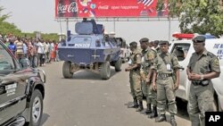 Nigerian bomb squad members stand guard in northern Nigeria, following the release of the presidential elections results.