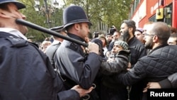 Police officers scuffle with demonstrators during a protest in support of Islamist cleric Abu Hamza al-Masri, during his appeal against extradition to the U.S., outside the High Court in London, October 5, 2012.