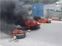 Burning tires block a main road in Gonaïves, Haiti, June 14, 2019.