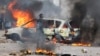 FILE - A protester looks on near a burning barricade during a "national shutdown" against the election outcome in Maputo, Mozambique, on Nov. 7, 2024.