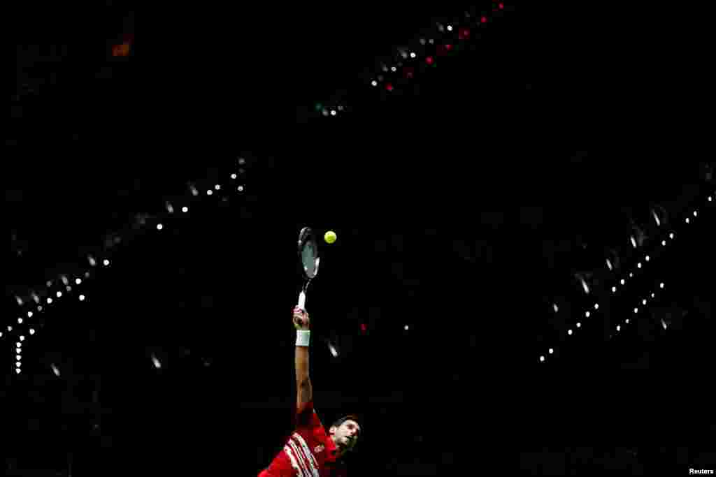 Serbia's Novak Djokovic serves to Benoit Paire of France during their tennis match at the Davis Cup Finals in Madrid, Spain.