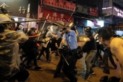 Policemen clash with demonstrators on a street during a protest in Hong Kong, Aug. 25, 2019.