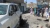 Police and residents gather at the site of a bomb blast in the Pakistan-Afghanistan border town of Chaman, Pakistan, May 21, 2021. 
