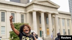 People react after a decision in the criminal case against police officers involved in the death of Breonna Taylor, who was shot dead by police in her apartment, in Louisville, Kentucky, Sept. 23, 2020.