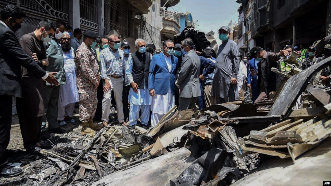 Para pejabat Pakistan meninjau lokasi jatuhnya pesawat Pakistan International Airlines, di kawasan permukiman di Karachi, Pakistan, Sabtu, 23 Mei 2020.