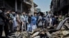 In this picture taken on May 23, 2020, and released by Pakistan's Civil Aviation Authority (PCAA), Pakistani officials inspect the site a day after a Pakistan International Airlines passenger plane crashed in a residential area in Karachi. 