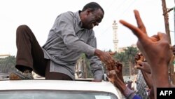 Ugandan opposition party leader Kizza Besigye shakes hands with supporters before being arrested on September 4, 2012 in Kampala, Uganda.