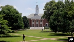 FILE - People walk on Johns Hopkins University's Homewood campus in Baltimore, Maryland.