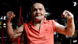 FILE- In this March 16, 2012, photo, Indian bodybuilder Manohar Aich flexes his muscles as he poses for a photograph at a gymnasium in Kolkata, India.