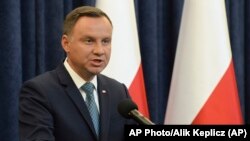 Polish President Andrzej Duda makes a statement in Warsaw, Poland, Monday, July 24, 2017. Duda said he would block two of three laws passed by the legislature that aimed at changing the judicial system. (AP Photo/Alik Keplicz)