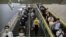 Commuters wearing face masks to protect against the spread of the new coronavirus walk through a subway station in Beijing, July 9, 2020.