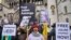 Demonstrators hold banners outside the Royal Courts of Justice in London, Feb. 20, 2024. Lawyers for WikiLeaks founder Julian Assange made his final appeal against his impending extradition to the United States at the court.