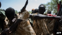 Child soldiers listen to a speech after being released from a group called the Cobra Faction and from the main SPLA/IO rebel faction during a ceremony in Tenet, near Pibor, South Sudan, Oct. 26, 2016. 