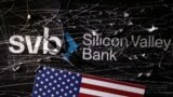 FILE PHOTO: Illustration shows destroyed SVB (Silicon Valley Bank) logo and U.S. flag