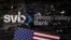 FILE PHOTO: Illustration shows destroyed SVB (Silicon Valley Bank) logo and U.S. flag