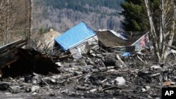 A house is seen destroyed in the mud on Highway 530 next to mile marker 37 in Oso, Washington, March 23, 2014.