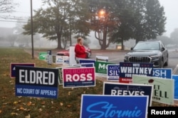 FILE - A woman walks near a polling station on the day of the 2024 U.S. presidential election in Raleigh, North Carolina, Nov. 5, 2024.