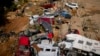 A man stands among cars destroyed in recent flooding in Valencia, Spain, Oct. 31, 2024.