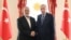 This handout photograph taken and released by Turkish Presidency Press Office on April 20, 2024, shows Turkish President Recep Tayyip Erdogan, right, shaking hands with Ismail Haniyeh, the political leader of Hamas, at the Dolmabahce Presidential working office in Istanbul.