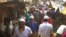 Rohingya refugees walk in market area inside a refugee camp in Ukhia on April 6, 2021 during the second day of weeklong  government-imposed lockdown amid an increase of COVID-19 coronavirus cases. (Photo by Miraj KATEB / AFP)