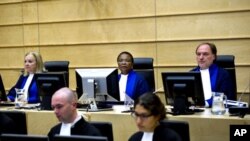 Judges Sylvia Steiner, Sanji Mmasenono Monageng, and Cuno Tarfusser, back row, from left, are seen in the courtroom in The Hague, Netherlands. The International Criminal Court (ICC) has issued arrest warrants for Libyan leader Moammar Gadhafi, his son and