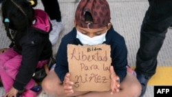 Migrants and asylum seekers demonstrate at the San Ysidro crossing port asking US authorities to allow them to start their migration process in Tijuana, Baja California state, Mexico on March 23, 2021.