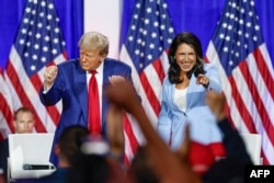 FILE - Former U.S. President Donald Trump leaves the stage with former U.S. Representative Tulsi Gabbard during a town hall meeting in La Crosse, Wisconsin, on Aug. 29, 2024. Trump said on Nov. 13, 2024, that he intended to nominate Gabbard as director of national intelligence.