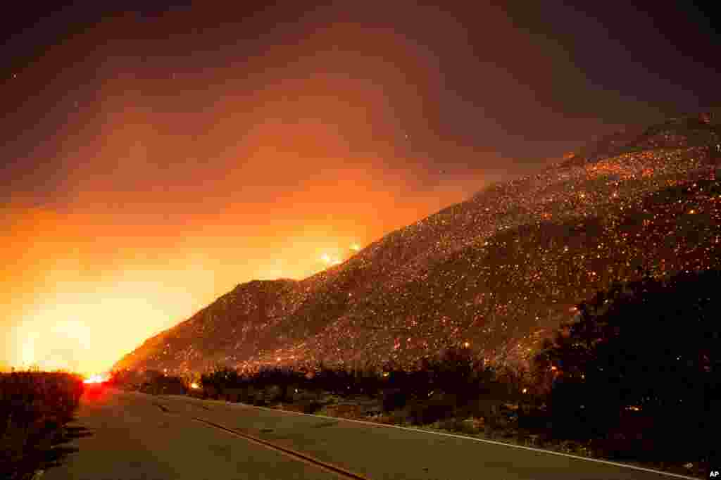 Embers from a wildfire smolder along Lytle Creek Road near Keenbrook, Calif., on Aug. 17, 2016. 