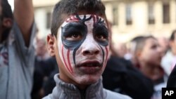 An Egyptian youth wears face paint at a demonstration outside the country's high court in Cairo, Egypt, April 6, 2013. 