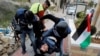 A wounded Palestinian photojournalist is evacuated during an anti-Israel protest against the U.S. President Donald Trump&#39;s Middle East peace plan, in Hebron in the Israeli-occupied West Bank.