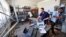 Staff remove damaged items following a bomb explosion at a police station by unknown assailants Benghazi, Libya, May 12, 2013.