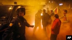 Union picketers try to stop a truck at the entrance of Malaga's main food warehouse, early March 29, 2012. 