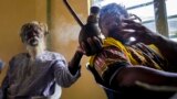 FILE - Rastafaris, Ras Jah and Ras Wilkins, pass a chalice pipe with marijuana, to the left during a service in the tabernacle on Sunday, May 14, 2023,