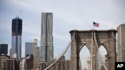 A view shows One World Trade Center (L) in New York City, April 30, 2012. The One World Trade Center, built on the Ground Zero site of the fallen World Trade Center towers, officially surpassed the Empire State Building as the tallest building in New York